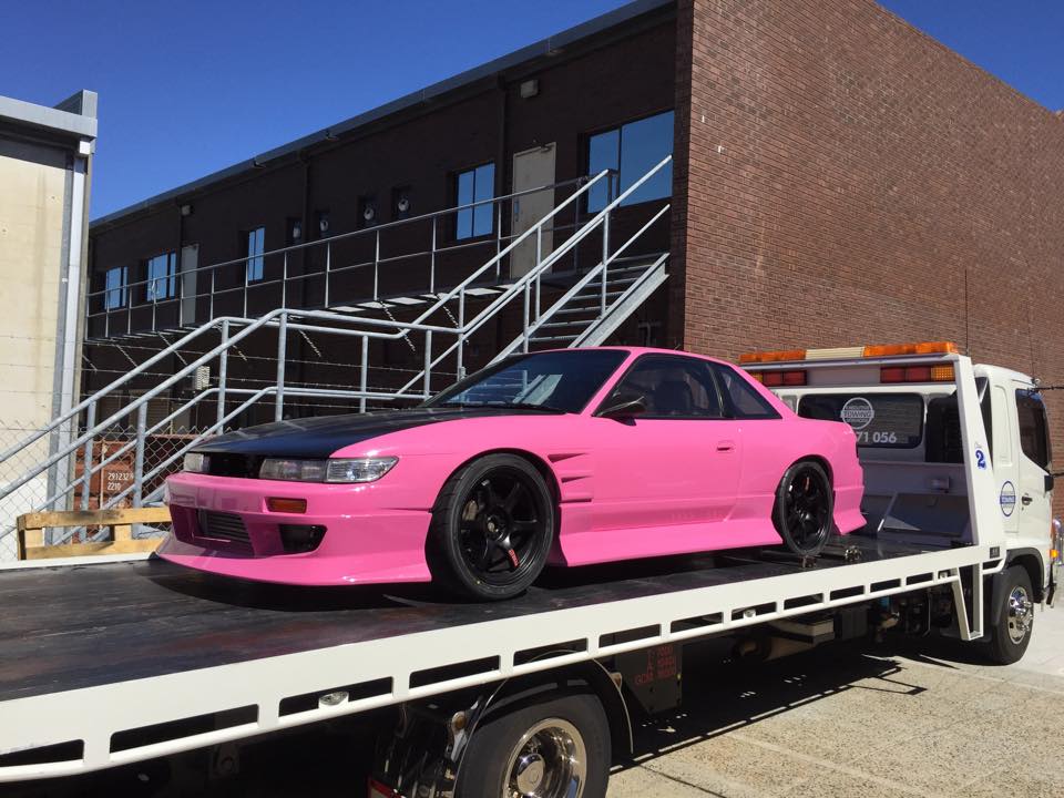 pink and black performance car on a tilt tray
